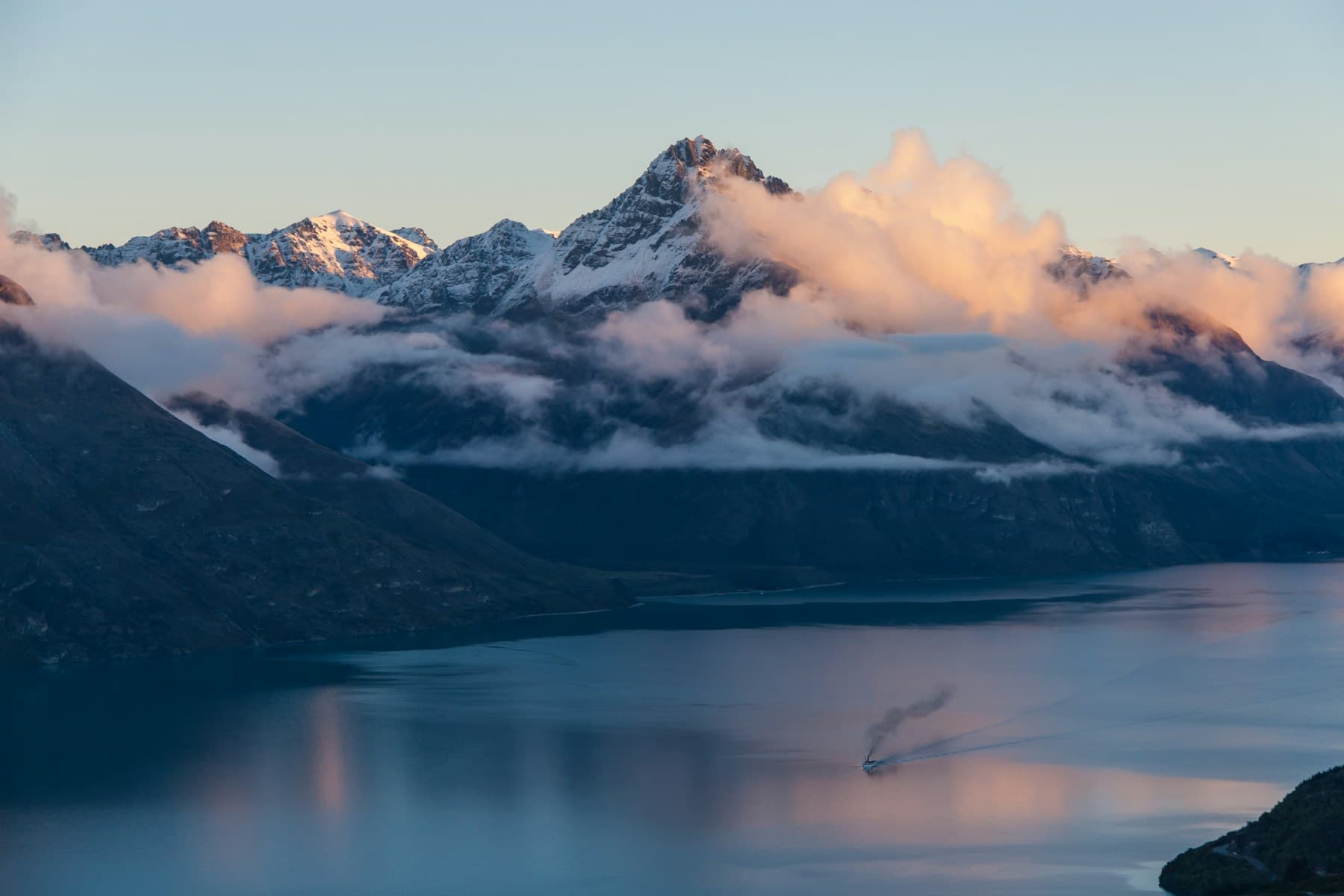 Snow-dusted mountains and clouds above Lake Wakatipu near Queenstown