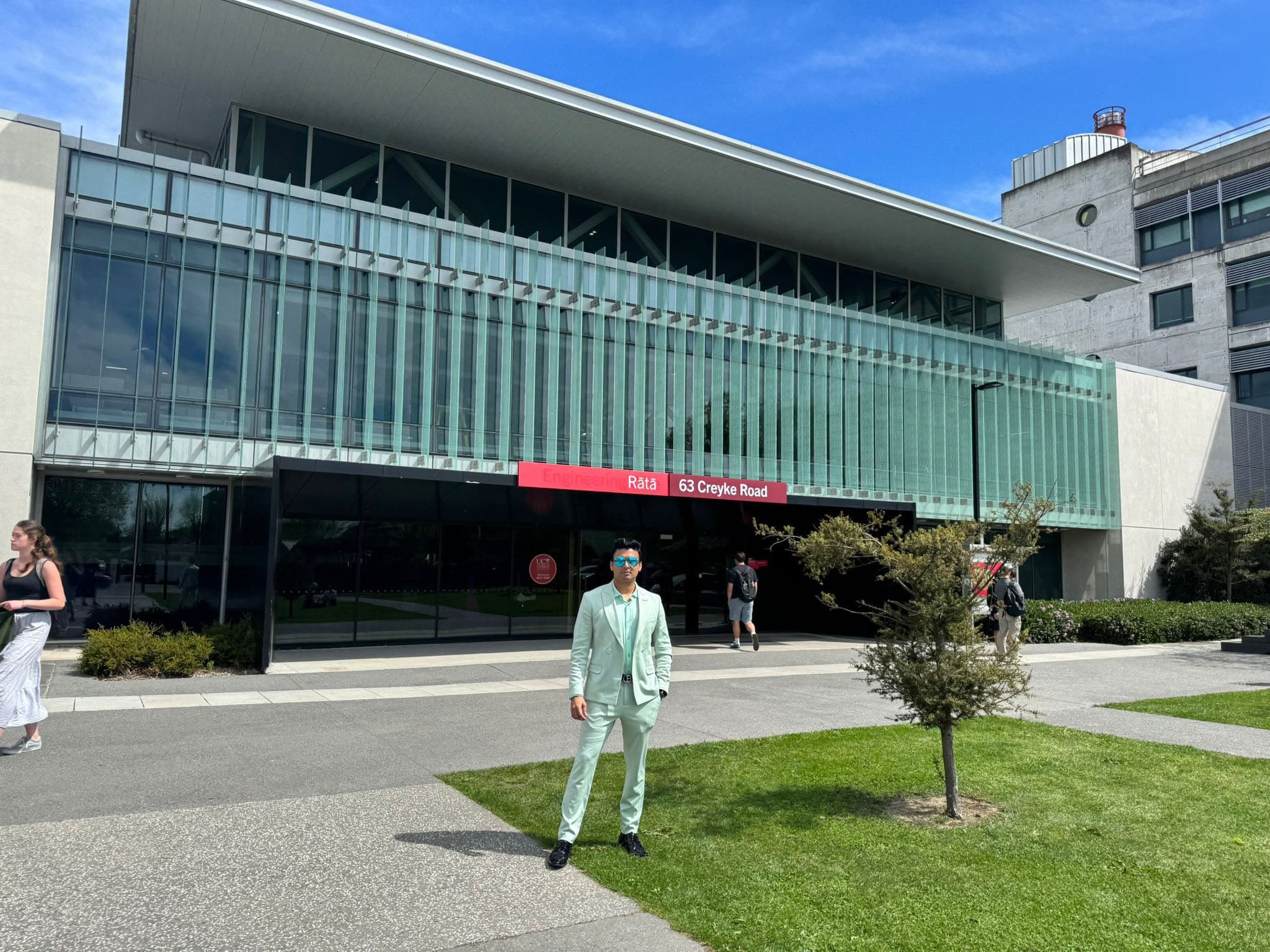 A visitor outside the glass-fronted Engineering Rātā building